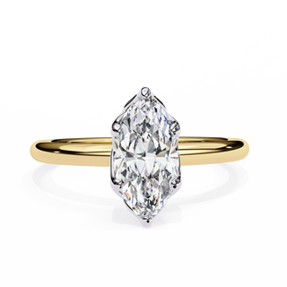 Gold ring with a marquise-shaped diamond on a white background