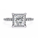 Diamond ring with a square-cut center stone on a white background