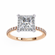 Rose gold ring with a large diamond and smaller diamonds on the band against a white background