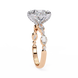 Rose gold ring with diamond accents on a white background