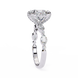 Diamond ring with a pear-shaped center stone on a white background