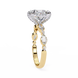 Gold ring with a large diamond and smaller diamonds on a white background