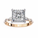 Rose gold ring with a large diamond and smaller diamonds on the sides against a white background