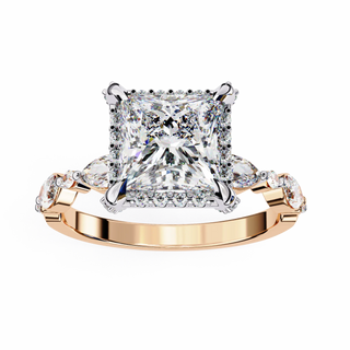 Rose gold ring with a large diamond and smaller diamonds on the sides against a white background