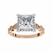 Gold ring with a large diamond and smaller diamonds on the band against a white background