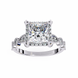Diamond ring with a large central gemstone and smaller stones on a white background