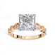 Rose gold ring with a large diamond and smaller diamonds on the band against a white background