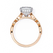 Rose gold ring with a large diamond and smaller diamonds on the band against a white background