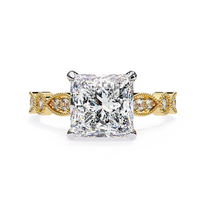 Gold ring with a large diamond and smaller diamonds on the band against a white background