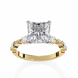 Gold ring with a large diamond and smaller diamonds on the sides against a white background