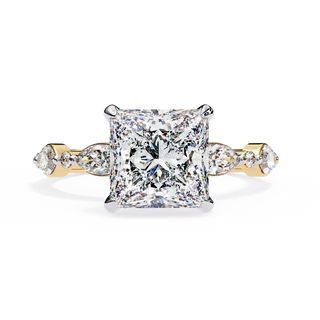 Diamond ring with a yellow gold band on a white background