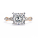 Diamond ring with a yellow gold band on a white background