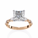 Rose gold ring with a large diamond and smaller diamonds on the sides against a white background