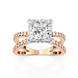 Rose gold ring with a large diamond and smaller diamonds on the band against a white background