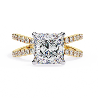 Gold ring with a large diamond and smaller diamonds on the band against a white background