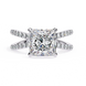 Diamond ring with a prominent central gemstone and smaller stones on the band against a white background