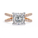 Rose gold ring with a large diamond and smaller diamonds on the band against a white background