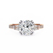 Rose gold ring with a large diamond and smaller diamonds on the sides against a white background