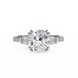 Diamond ring with a large central gemstone and smaller stones on a white background