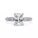 Diamond ring with a large central gemstone and intricate side details on a white background