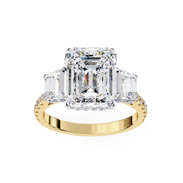 Gold ring with a large diamond and smaller emerald-cut diamonds on a white background