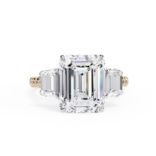 Diamond ring with emerald-cut center stone on a white background