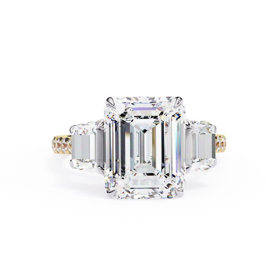 Diamond ring with emerald-cut center stone on a white background