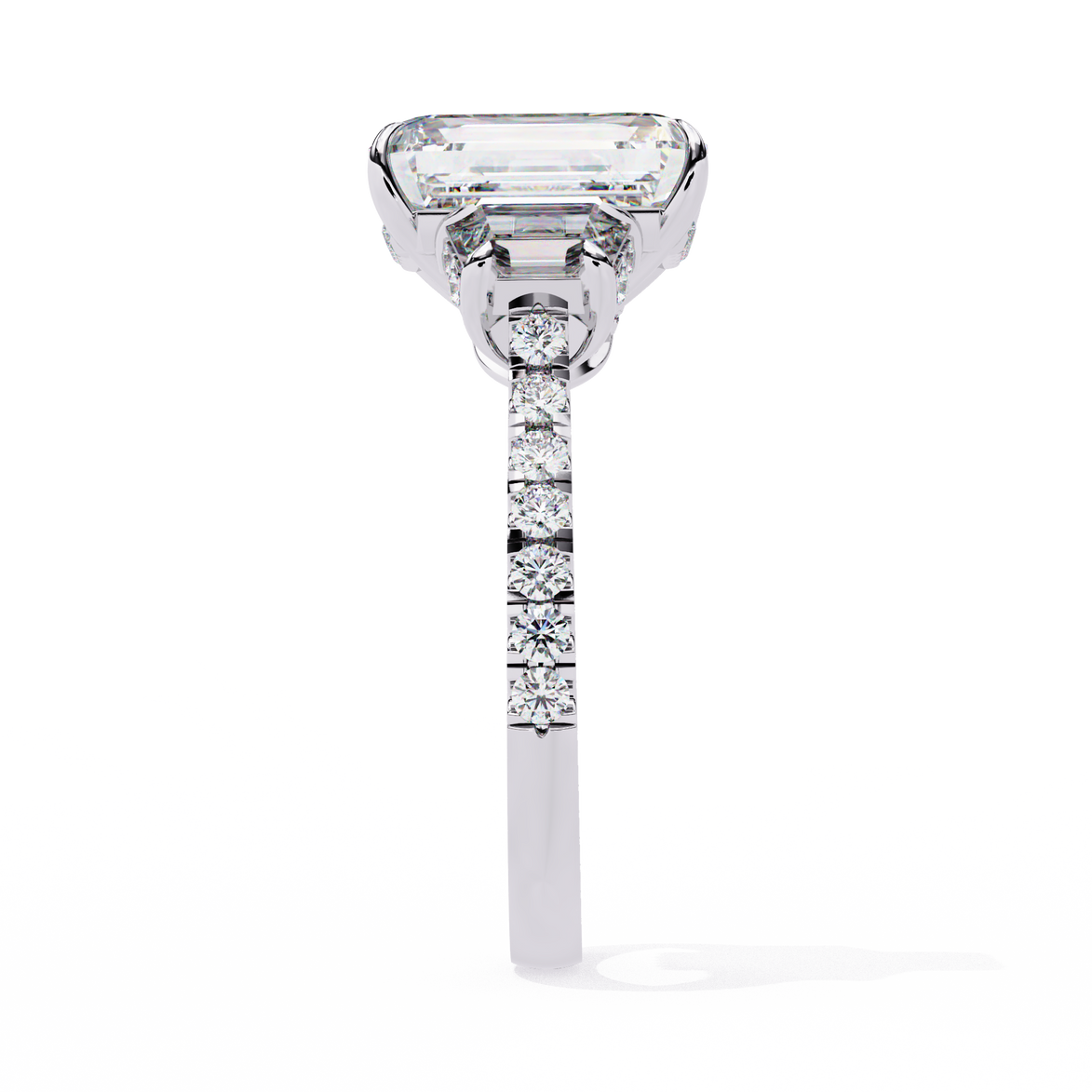 Diamond ring with a rectangular center stone on a white background