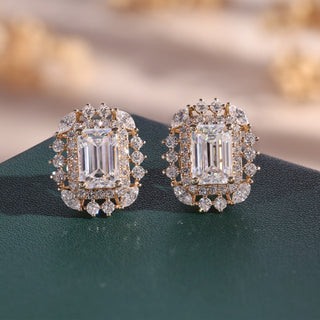 Yellow gold emerald cut lab grown diamond halo stud earrings with prong-set centers, round halos and marquise accents.