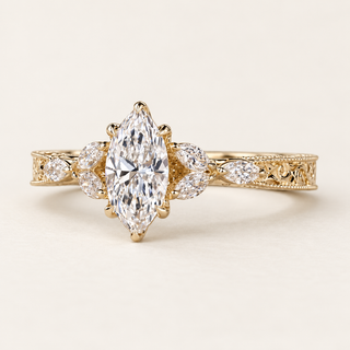 Marquise cut lab grown diamond engagement ring with marquise diamond side stones, beaded milgrain borders and vintage openwork shoulders in yellow gold
