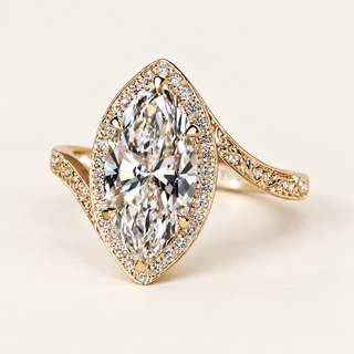Marquise cut lab grown diamond engagement ring with elongated center, full pavé diamond halo, sculpted bypass shoulders and decorative openwork in yellow gold.