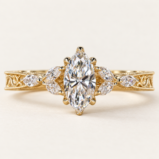Marquise cut lab grown diamond engagement ring with marquise diamond side stones, beaded milgrain borders and vintage openwork shoulders in yellow gold