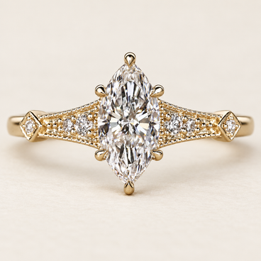 Marquise cut lab grown diamond cathedral engagement ring with a prong-set center, pavé diamond shoulders, Art Deco milgrain and geometric yellow gold detailing.