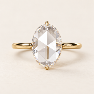 Oval rose cut lab grown diamond engagement ring in yellow gold with four claws at the ends and side midpoints and a plain polished band