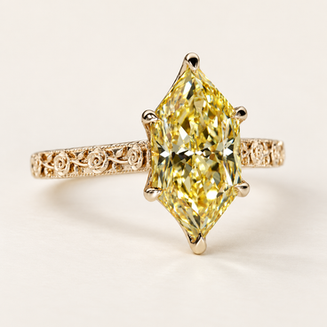 Fancy yellow Dutch marquise cut lab grown diamond engagement ring with protective pointed-end prongs, engraved floral shoulders and milgrain detailing in polished yellow gold.