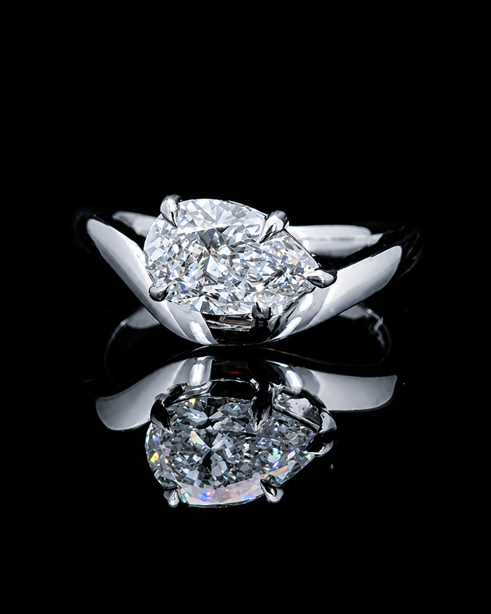 Main: White gold 1.00ct pear twist solitaire ring with lab grown diamond centre on black
Detail: Close-up of 1.00ct pear lab grown diamond held in a sculptural white gold setting
Side: White gold pear solitaire ring with flowing crossover twist shoulders and raised setting