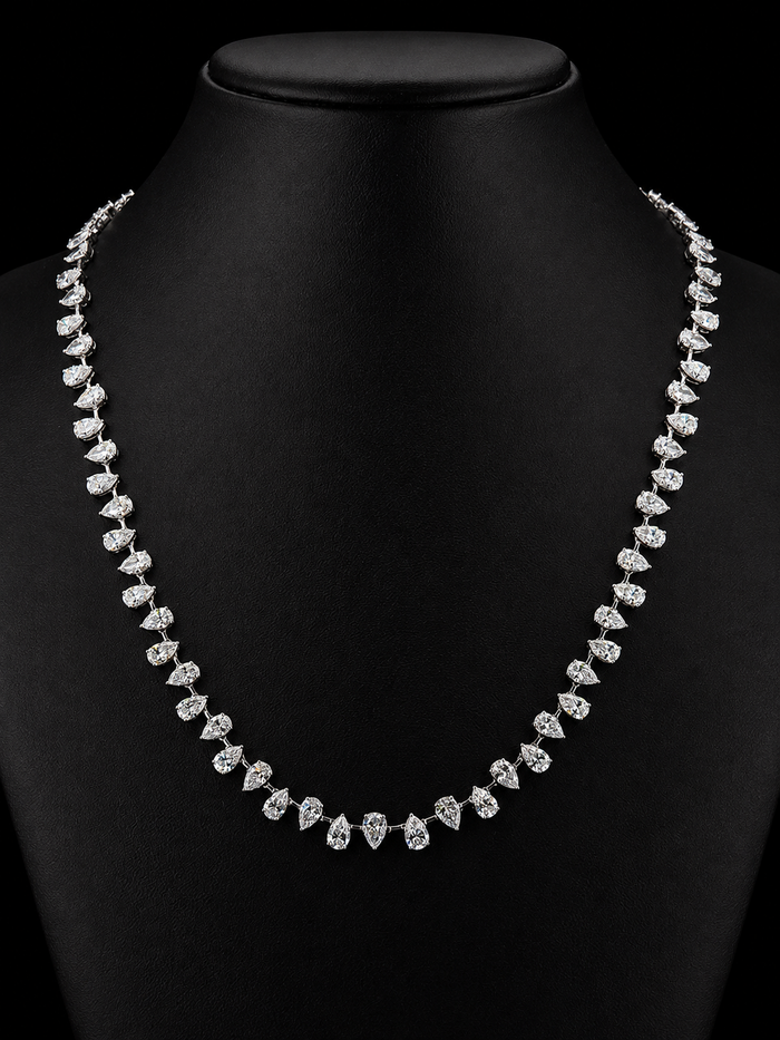White gold tennis necklace with 25.94ct pear shaped lab grown diamonds photographed on black