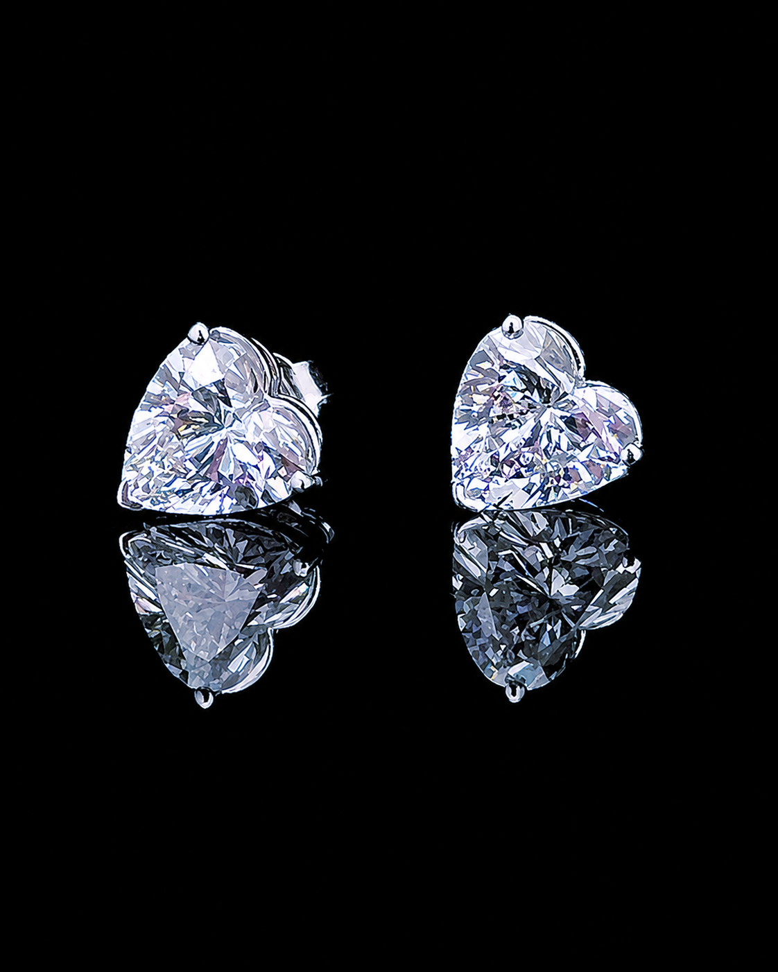 White gold heart solitaire stud earrings with lab grown diamonds photographed on black