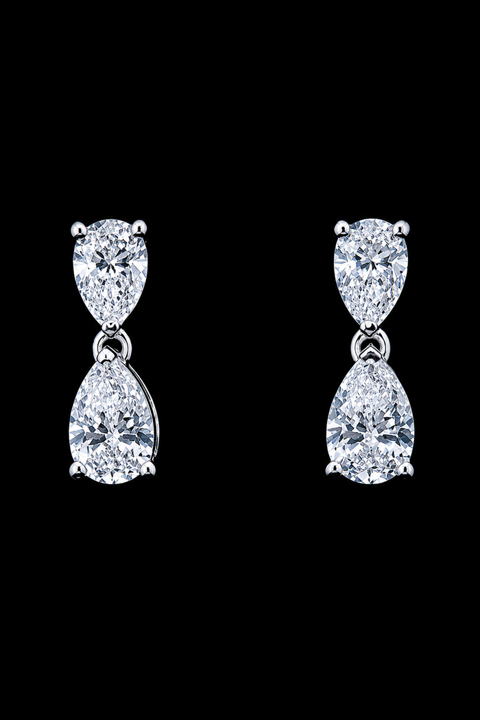 White gold pear drop earrings with four lab grown diamonds on black