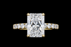 Yellow gold ring with 5.25ct radiant lab grown diamond and pavé diamond band on black