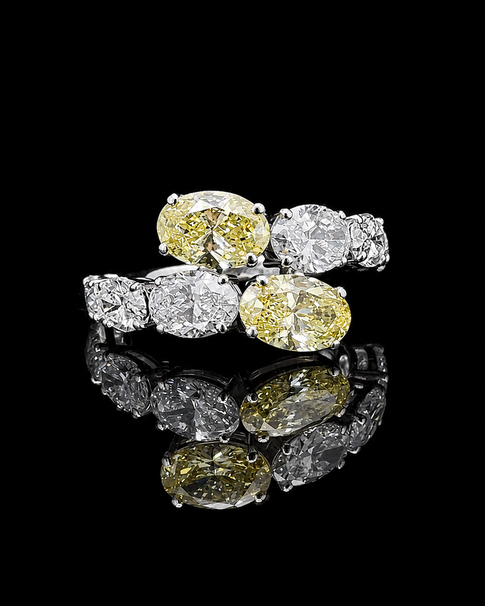 White gold oval mosaic ring with eight graduated lab grown diamonds on black
