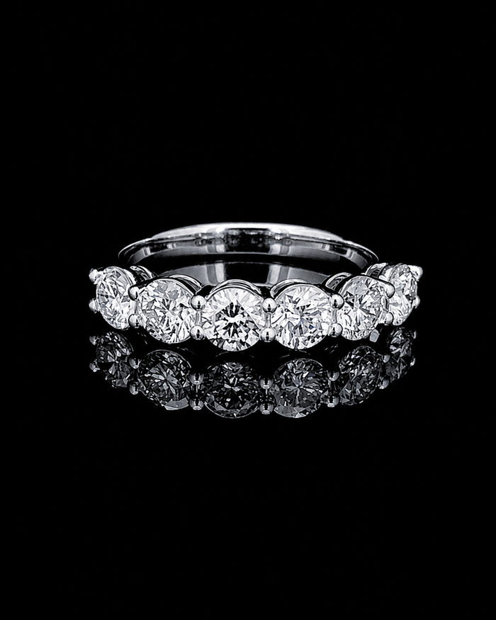 The Celeste seven-stone lab-grown diamond band in white gold on a black reflective background
