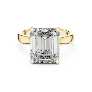 emerald diamond cathedral engagement ring in yellow gold
