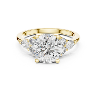 round diamond pear and round engagement ring in yellow gold
