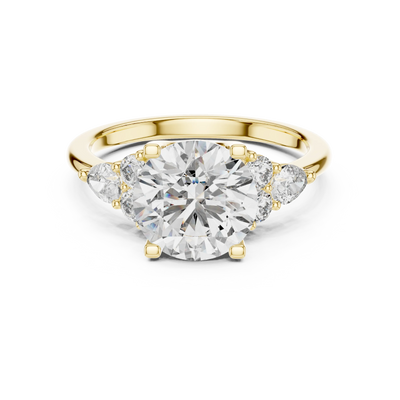 round diamond pear and round engagement ring in yellow gold
