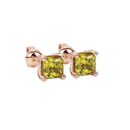 Close-up, princess canary yellow gemstone earrings, rose gold basket setting