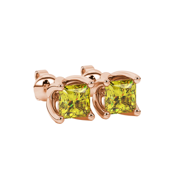 Close-up, princess canary yellow gemstone earrings, rose gold tulip setting.