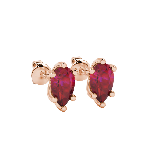 Close-up, pear shape raspberry red gemstone earrings, rose gold six-prong setting.