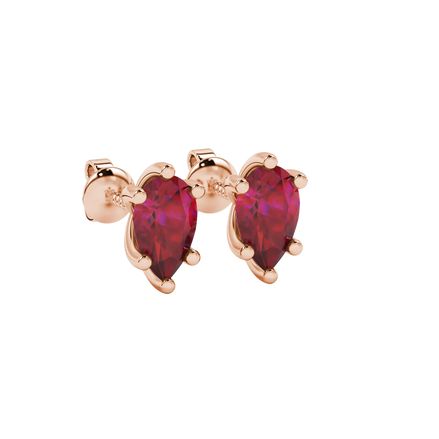 Close-up, pear shape raspberry red gemstone earrings, rose gold six-prong setting.