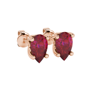 Close-up, pear shape raspberry red gemstone earrings, rose gold lotus basket.